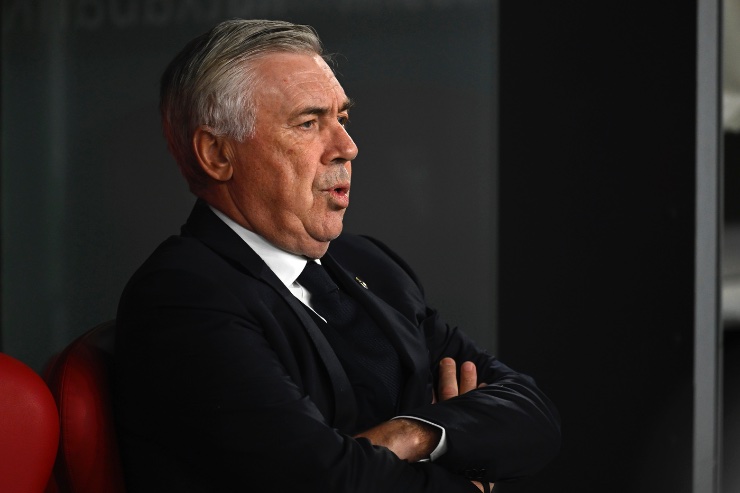 Ancelotti seduto in panchina a braccia conserte